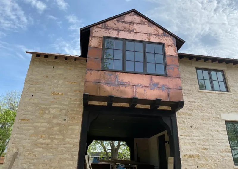 Copper metal panel facade on a stone building for Metal Roof Coating in Lemay