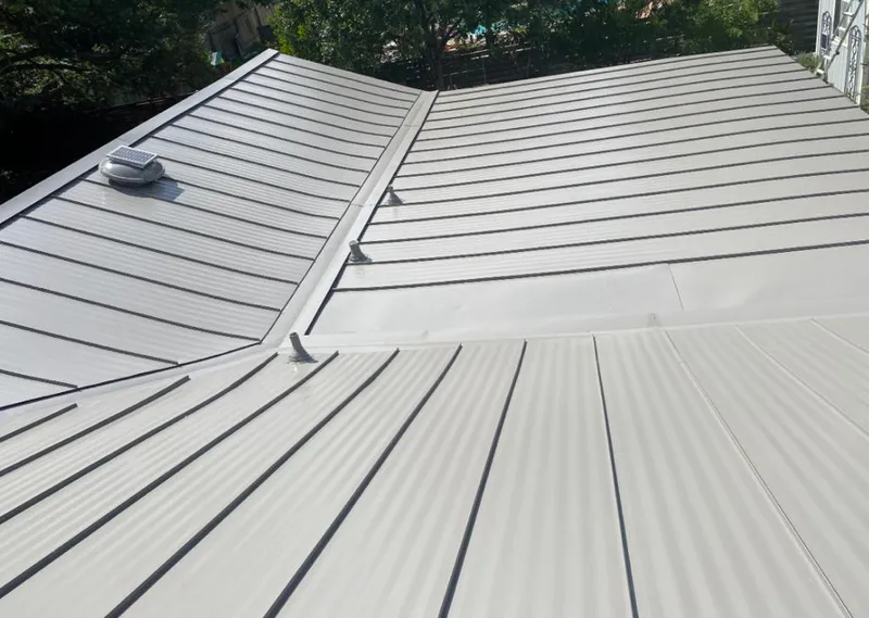 Solar attic fan installed on a metal roof for Roof Ventilation in Lemay